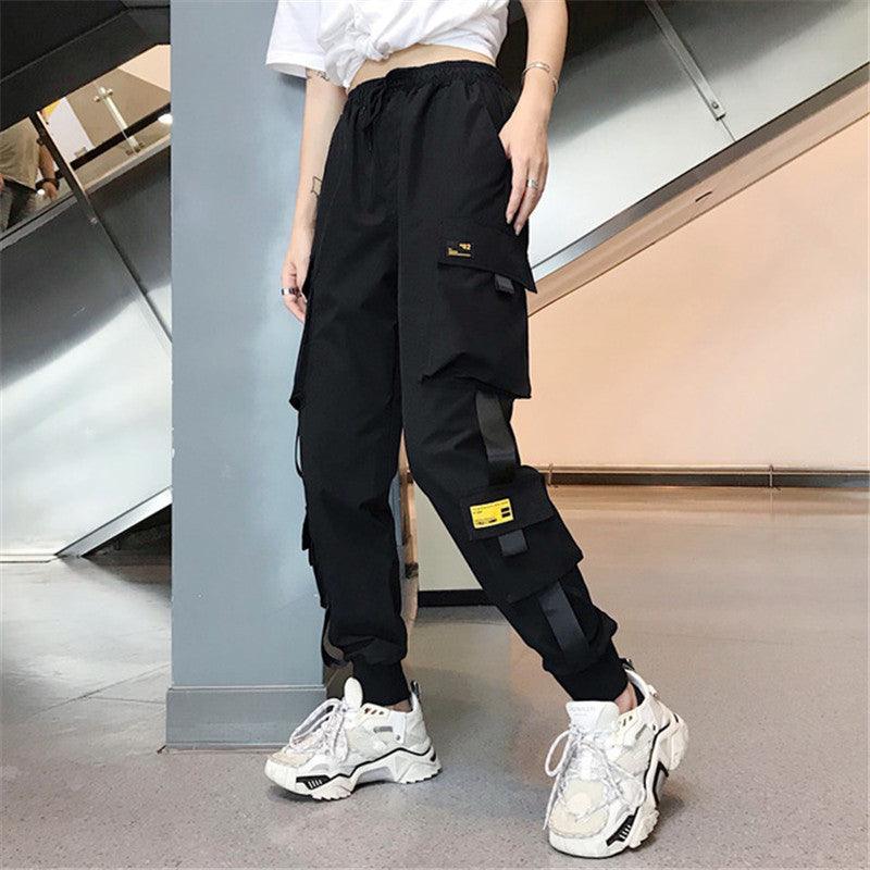Women's black cargo pants with layered side pockets and drawstring waist