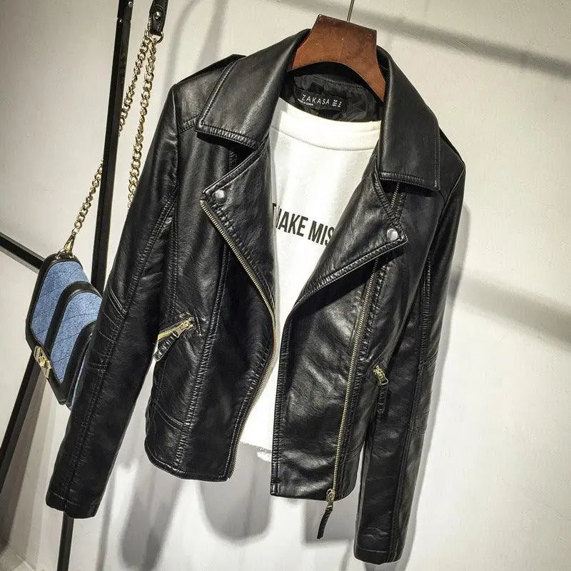 Black motorcycle leather jacket on hanger with lapel collar and zippered pockets