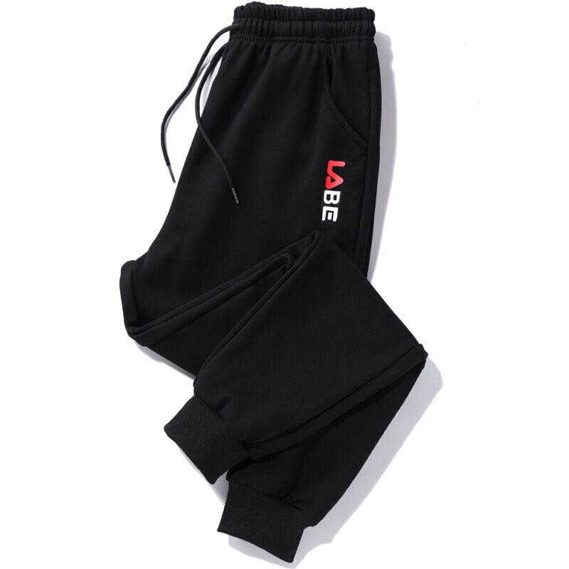 Black jogger trousers with drawstring waist, elastic cuffs, side pocket, and blue vertical logo