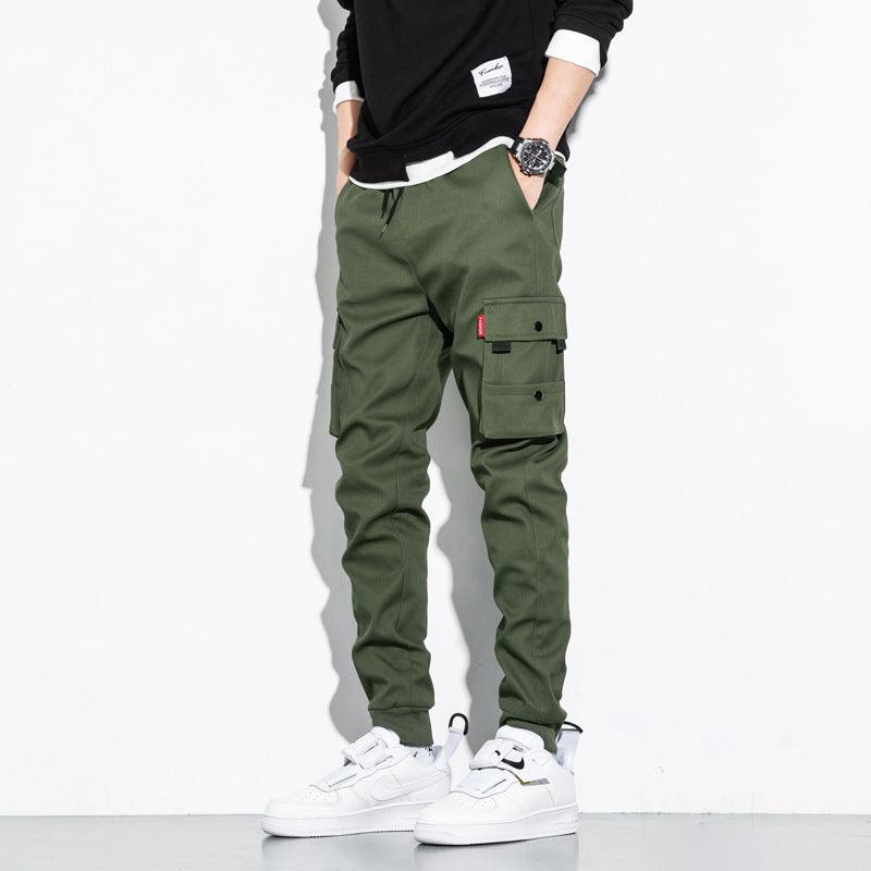 Green cotton cargo trousers with side cargo pocket and utility strap detail