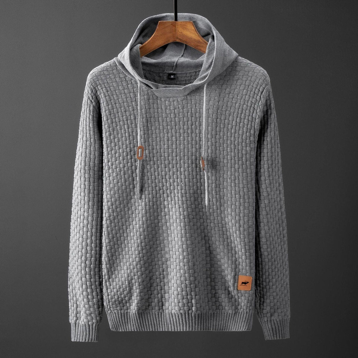 Light gray textured pullover sweater with hood and drawstring, long sleeves