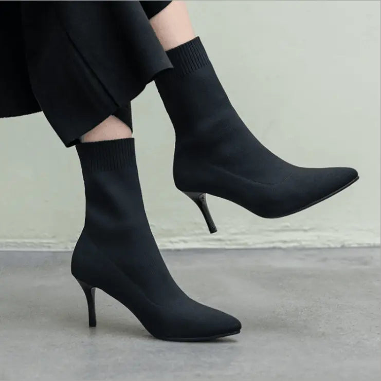 Black high-heel ankle boots, side view with slim stiletto heel