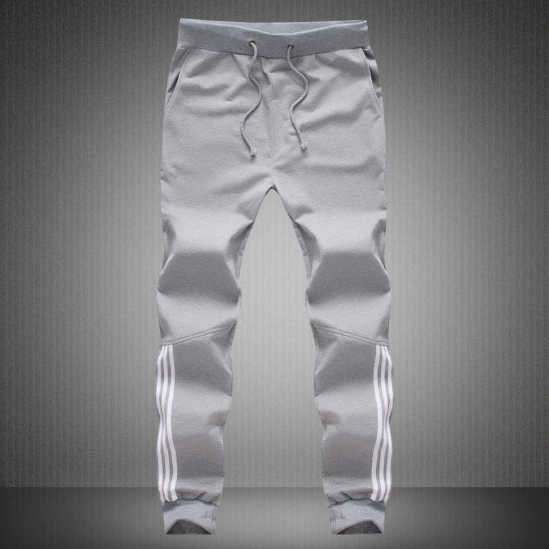 Men's light grey jogger pants with white side stripe accents and drawstring waist