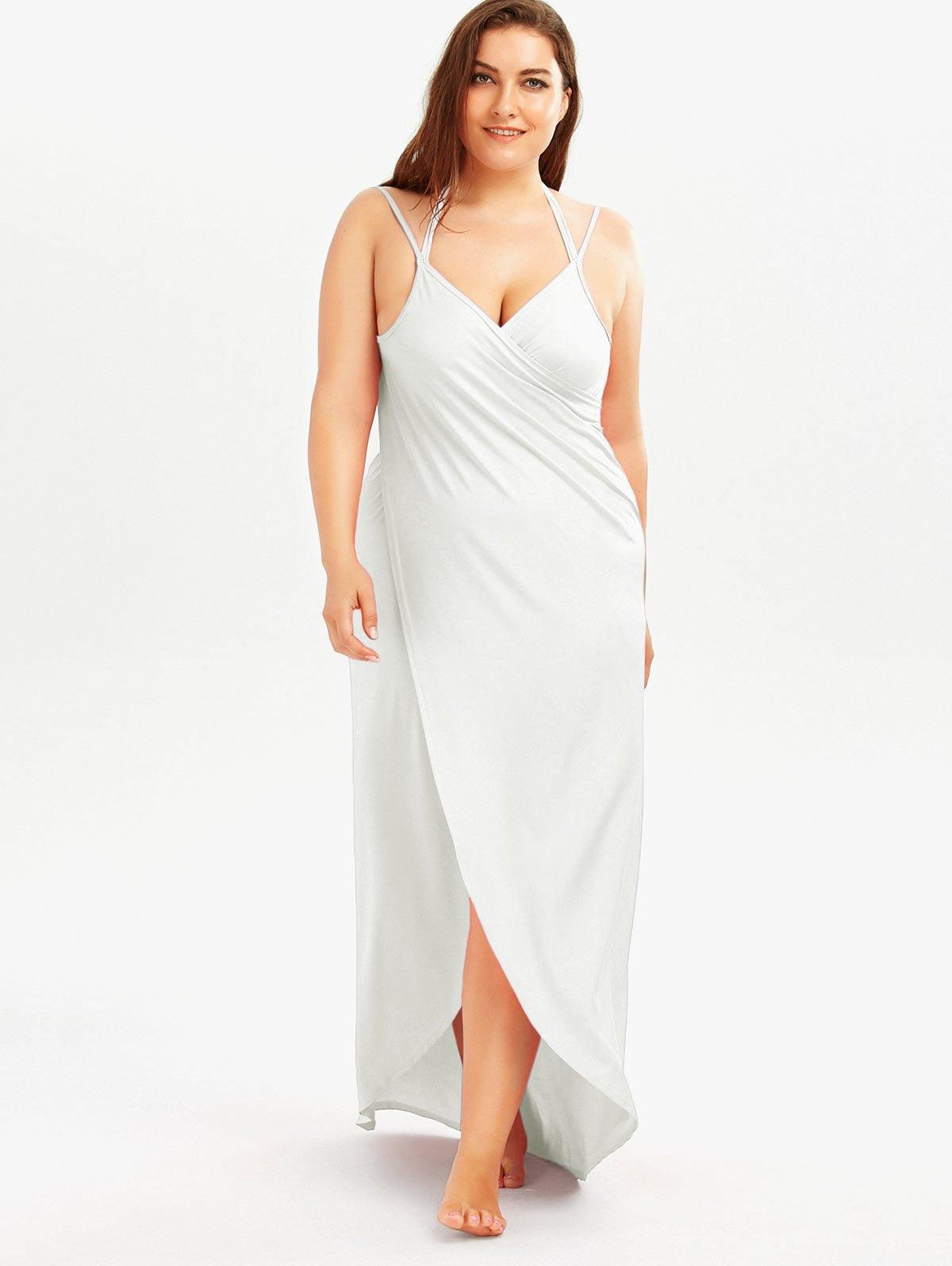 White maxi beach dress with spaghetti straps, V-neck wrap bodice, side slit.