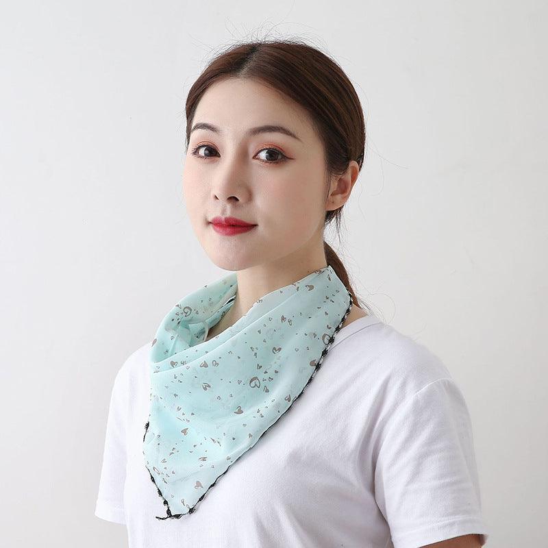 Mint printed sunscreen face mask scarf, draped at neck with black trim and side ties.
