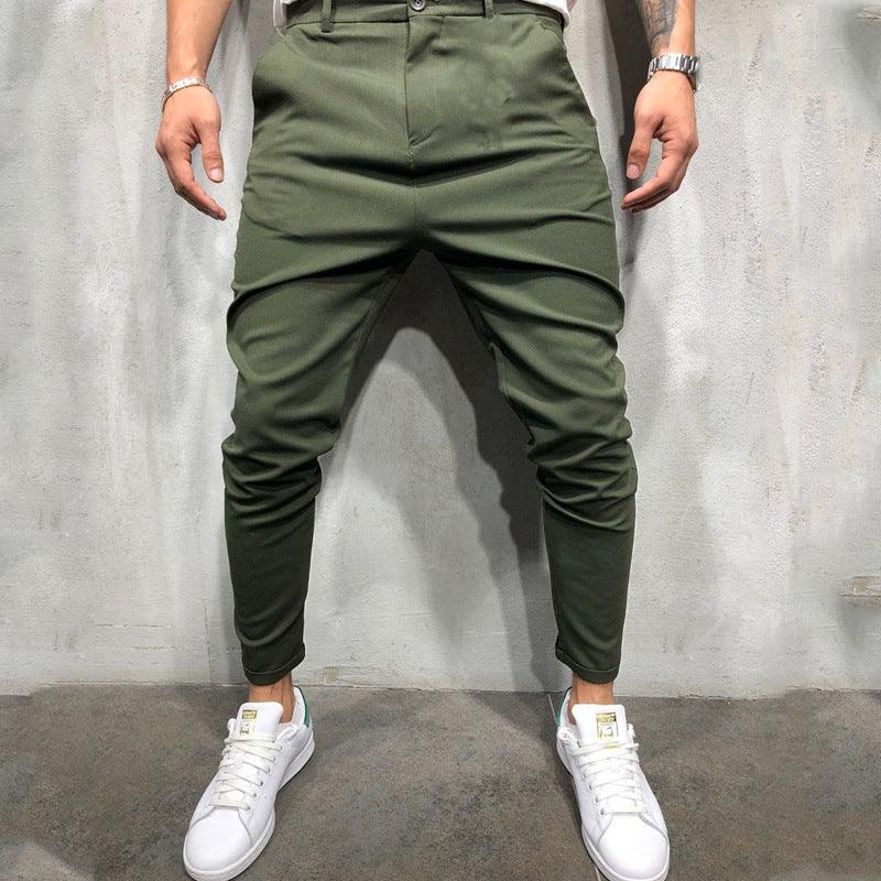 Green slim-fit casual pants with button waist, tapered legs, and front slash pockets