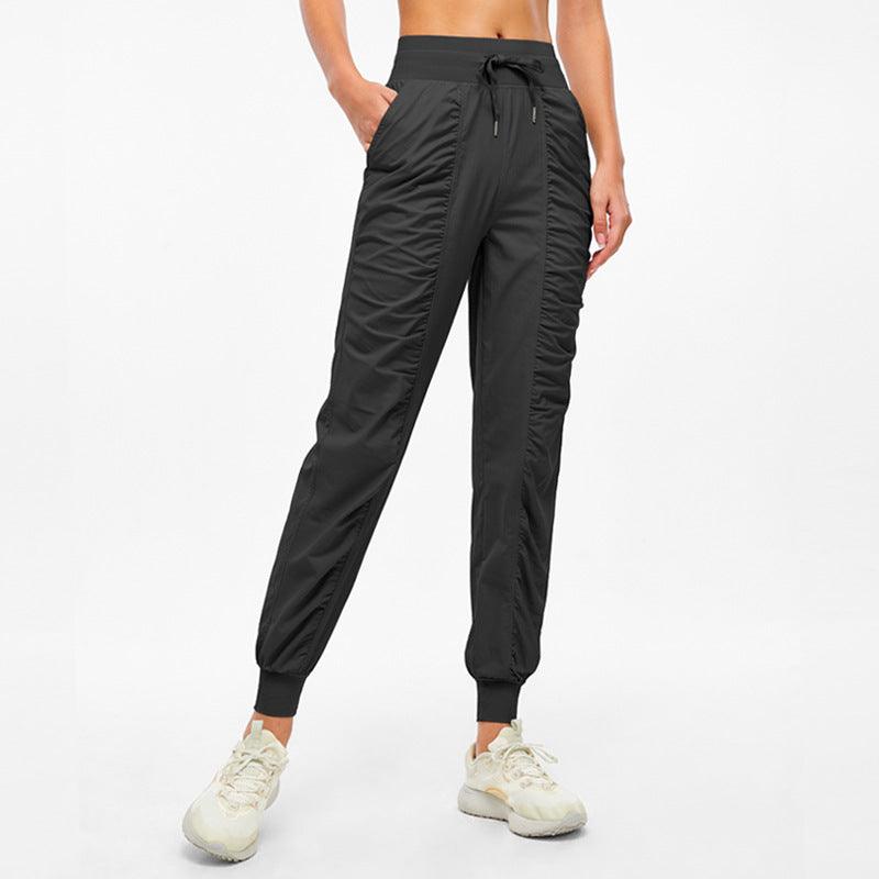 Black jogger pants with drawstring waist and tapered ankle cuffs