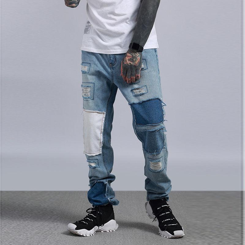 Light blue patchwork jeans with white panels, distressed rips and worn knee areas