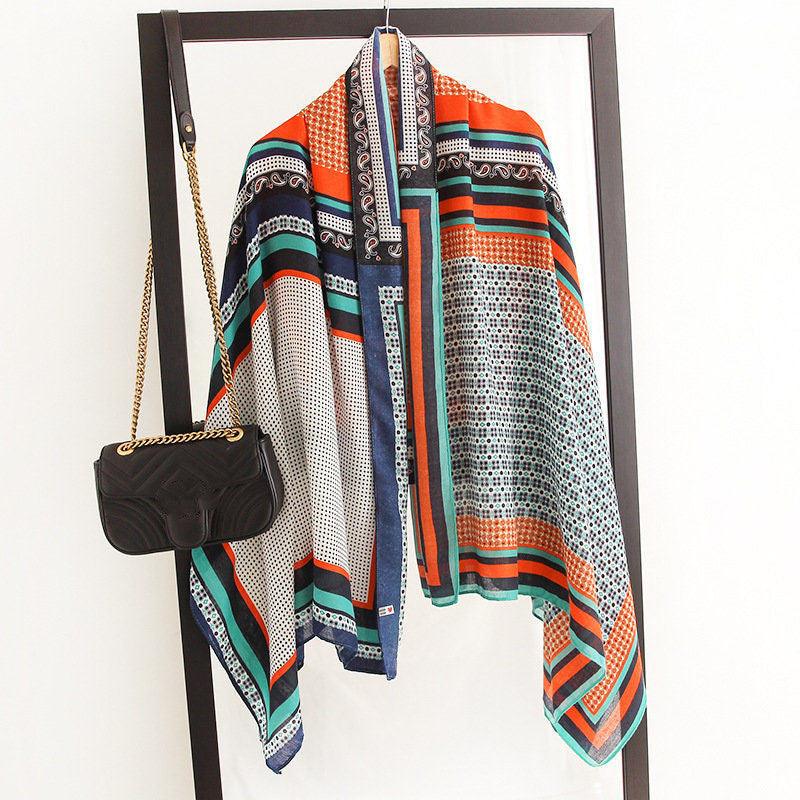 Silk scarf with multicolor geometric blocks in teal, orange, blue, and white