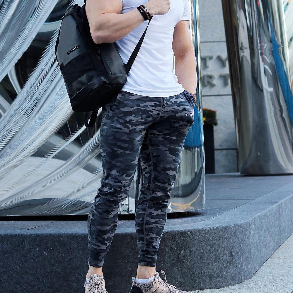 Mens camouflage jogger trousers, dark pattern with tapered legs and ankle cuffs