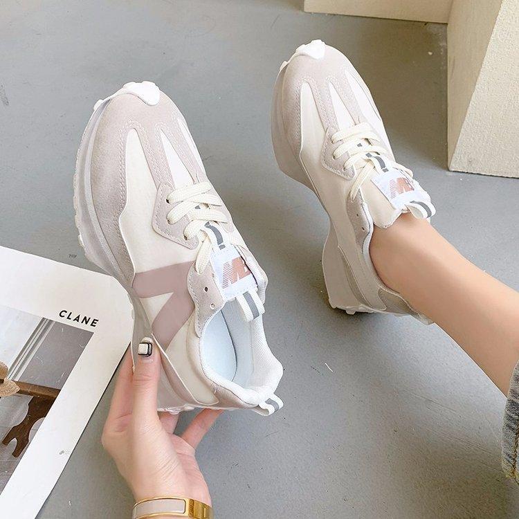 Beige thick-soled lace-up sneakers with white laces and padded collar