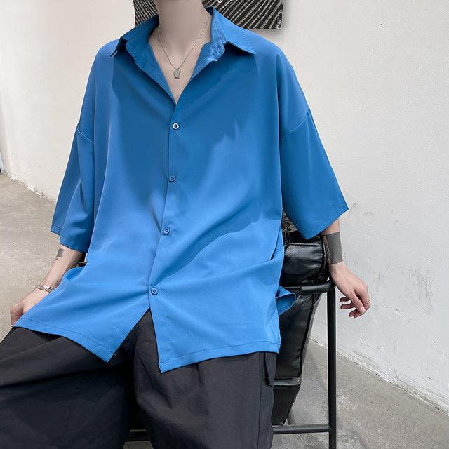 Blue half-sleeve button-up shirt with spread collar and center button placket