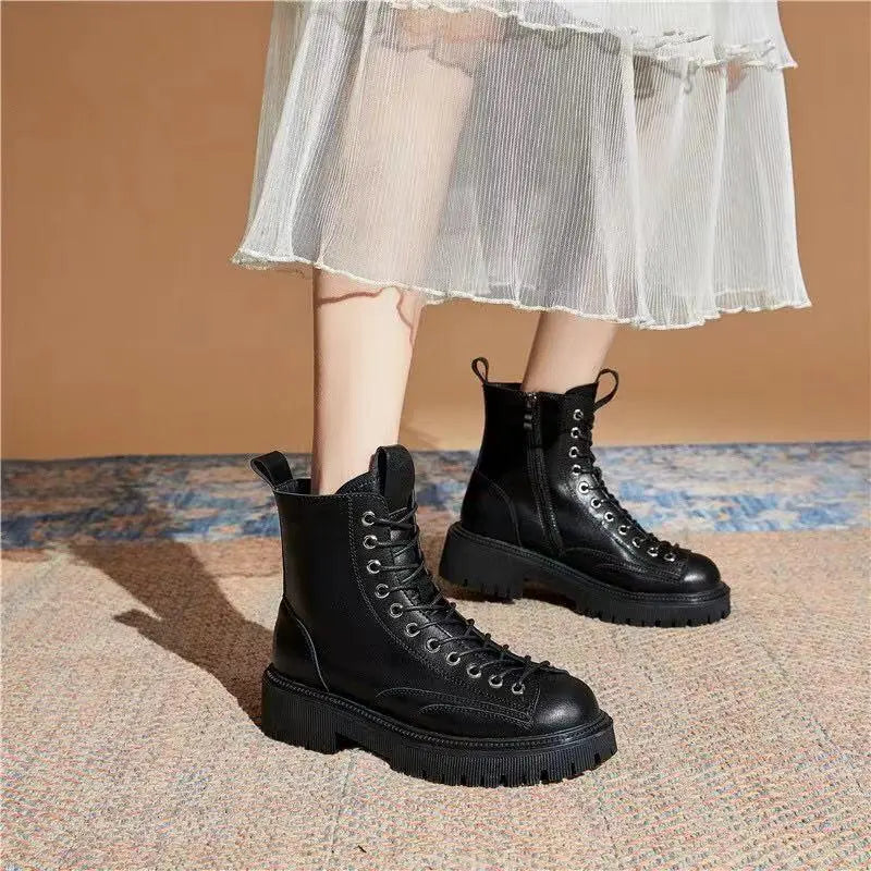 Black lace-up ankle boots with round toe, metal eyelets, and chunky platform sole