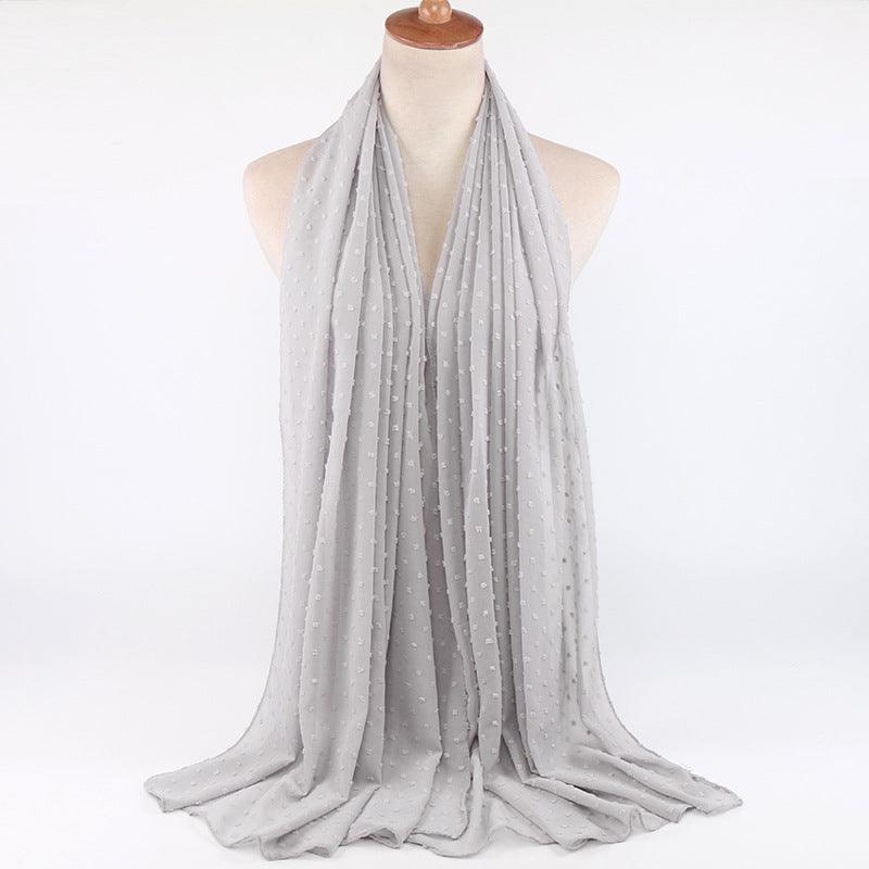 Chiffon folk ball scarf in light grey with small dotted pattern, gently draped