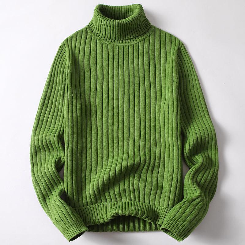 Green knit turtleneck sweater with thick ribbed texture and long sleeves.