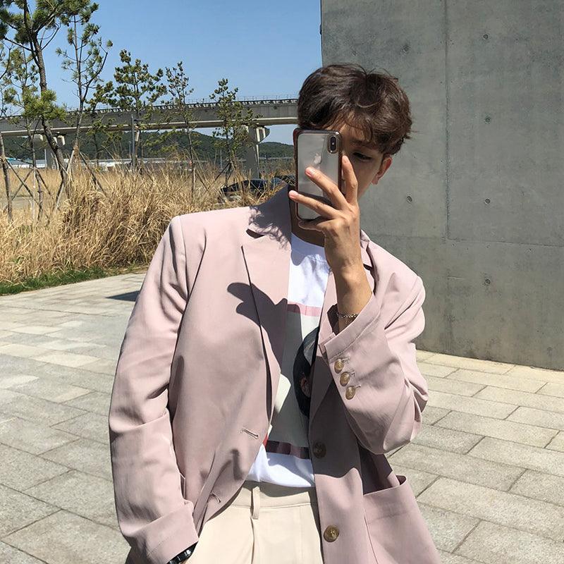 Pink casual blazer jacket with notch lapels and button front, long sleeves.