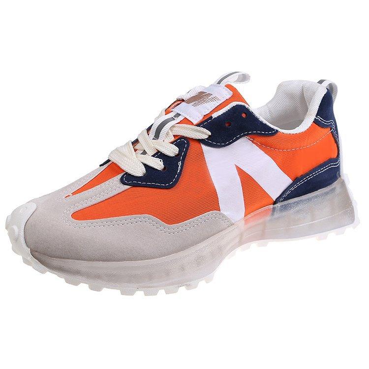 Orange and navy thick-soled lace-up sneakers with white laces and transparent sole