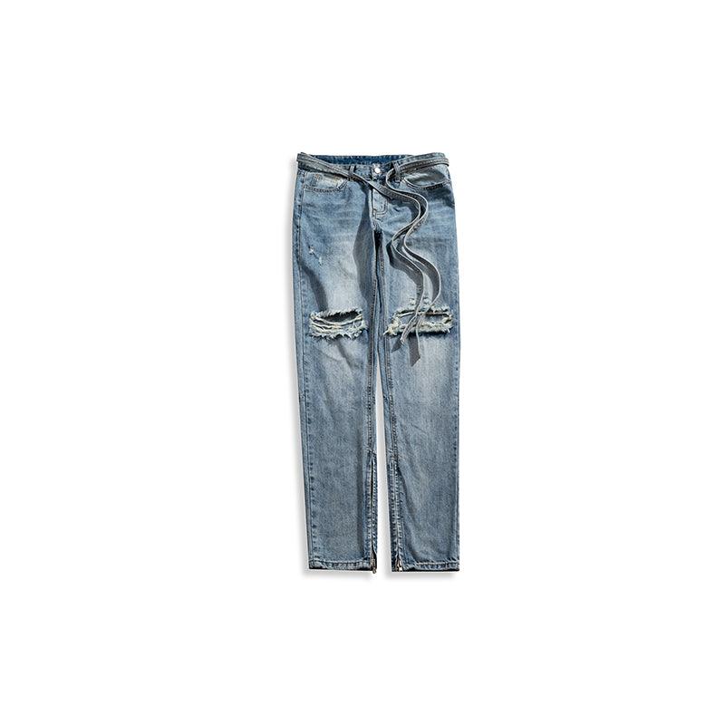 Blue denim jeans flat lay with ripped knees, frayed cuffs, and drawstring waist