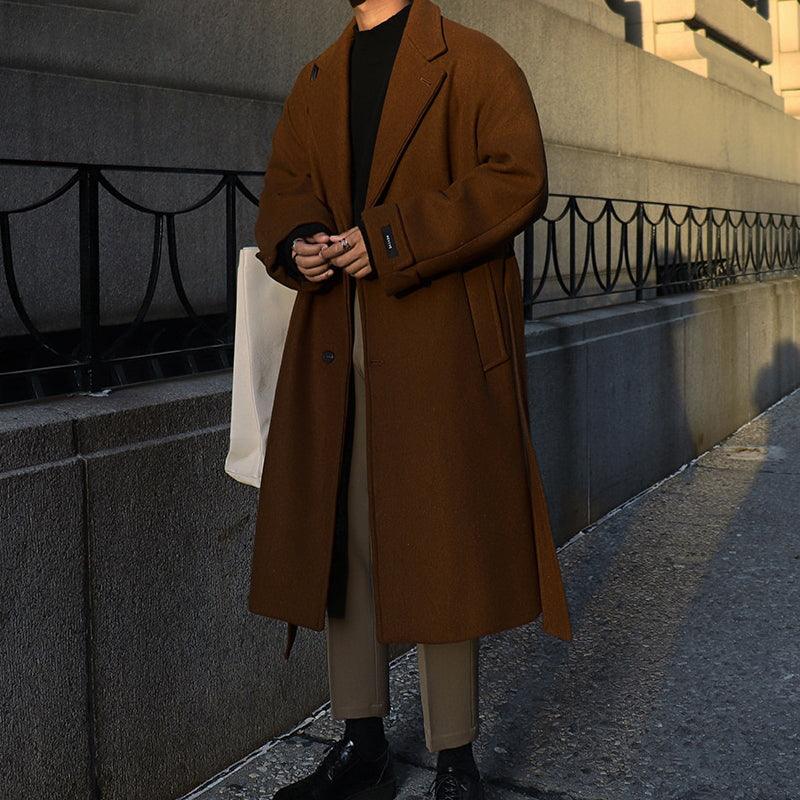 Brown mid-length trench coat with notched lapels, side pockets, and waist belt