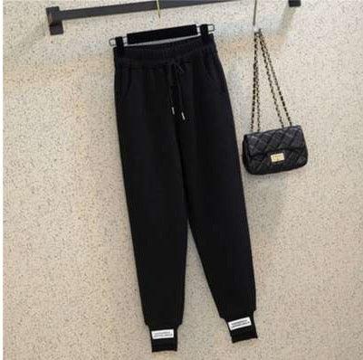 Black harem jogger trousers with elastic waistband, drawstring, and cuffed ankles