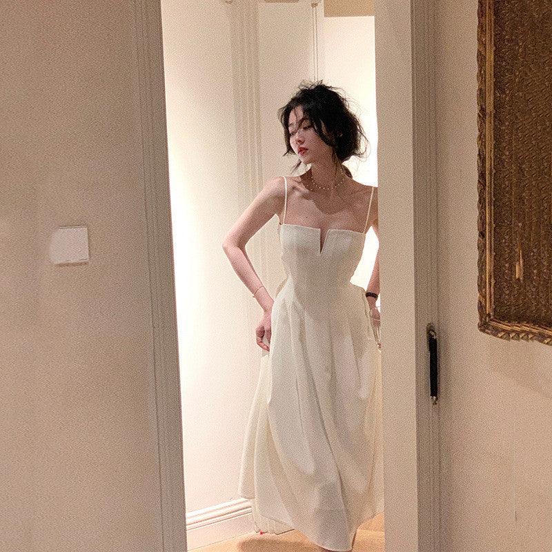White retro spaghetti-strap dress with square neckline, fitted bodice, pleated midi skirt