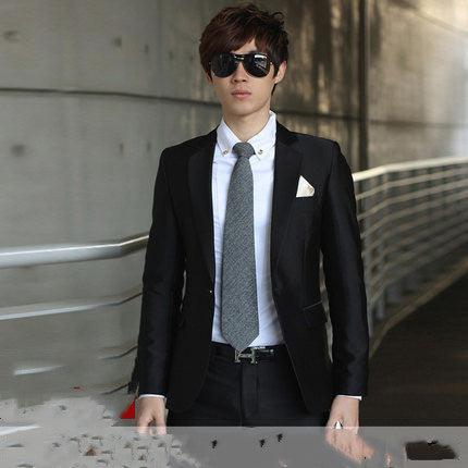 Slim-fit men’s suit in black with vest, white shirt, and black patterned tie.
