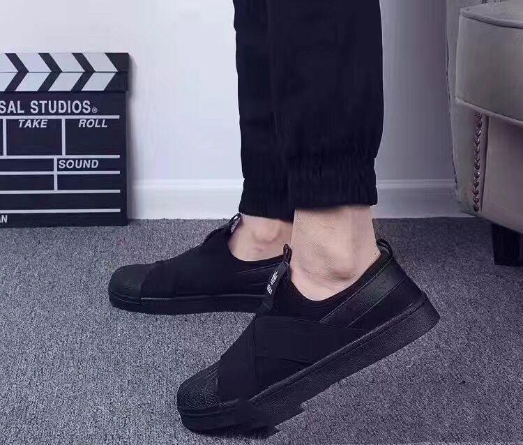 Black cross-strap couple sneakers, low-top slip-on with textured upper