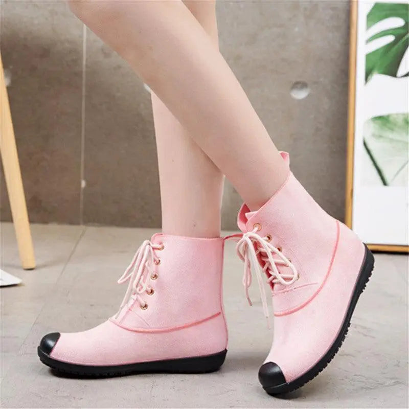 Waterproof lace-up Martin boots in pink with black rubber toe and laces