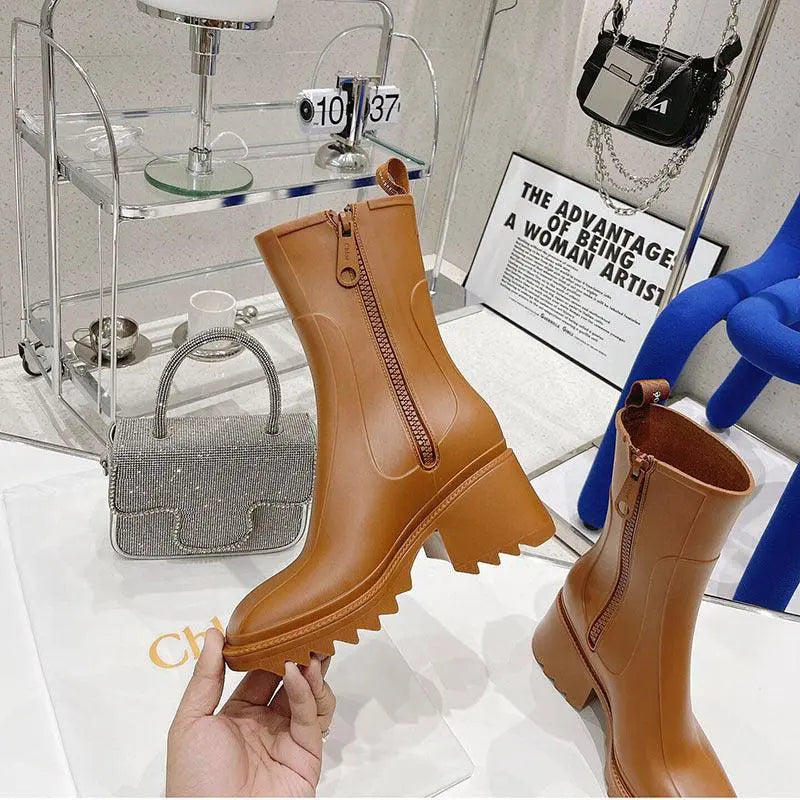 Tan mid-tube rain boots with thick lug sole and side zipper