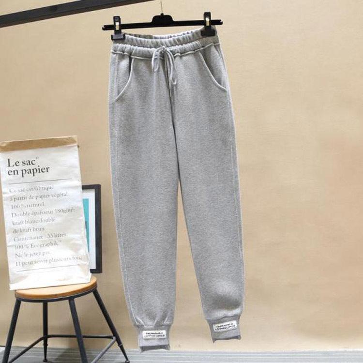 Light grey harem jogger trousers with elastic waistband, drawstring, cuffed hems