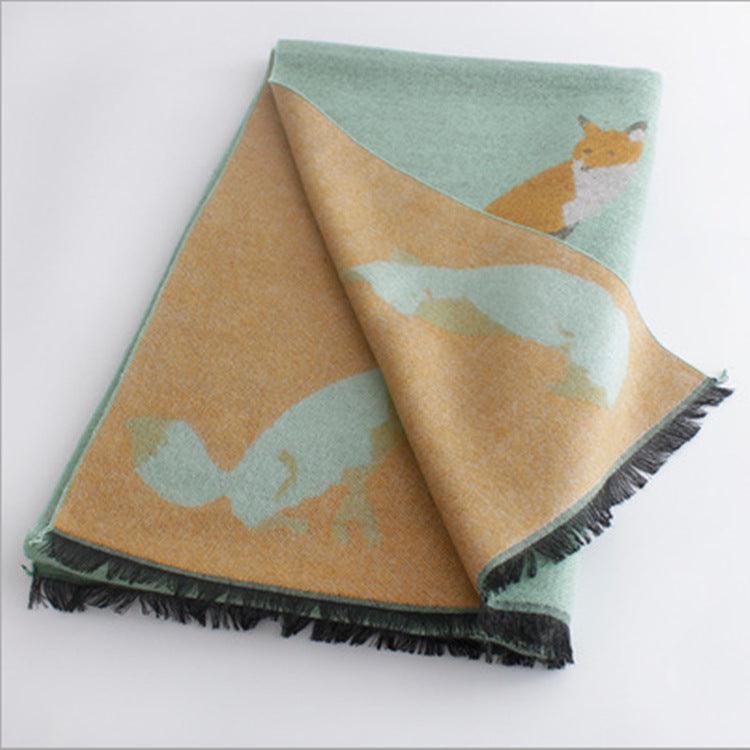 Thick warm jacquard scarf in mint green and beige with fox silhouettes, fringed ends