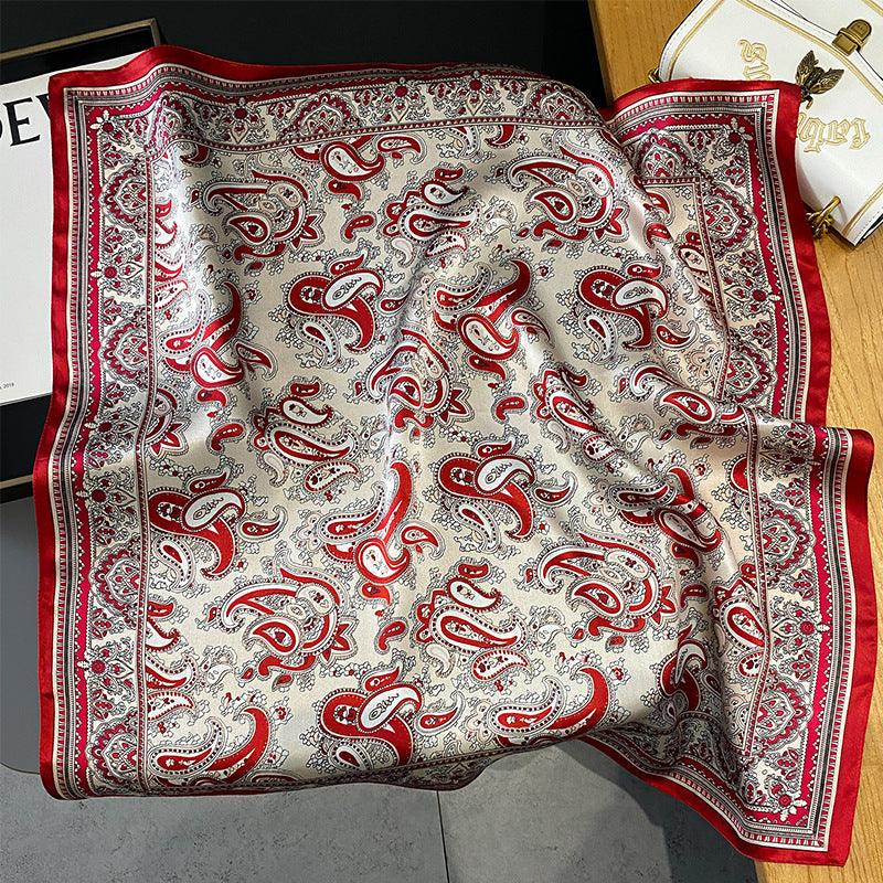 Light gray silk scarf with red paisley pattern and dark red ornate border.