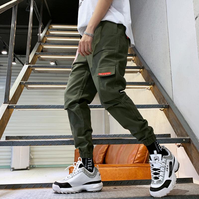 Men's dark green cargo pants with side flap pockets and ankle cuff