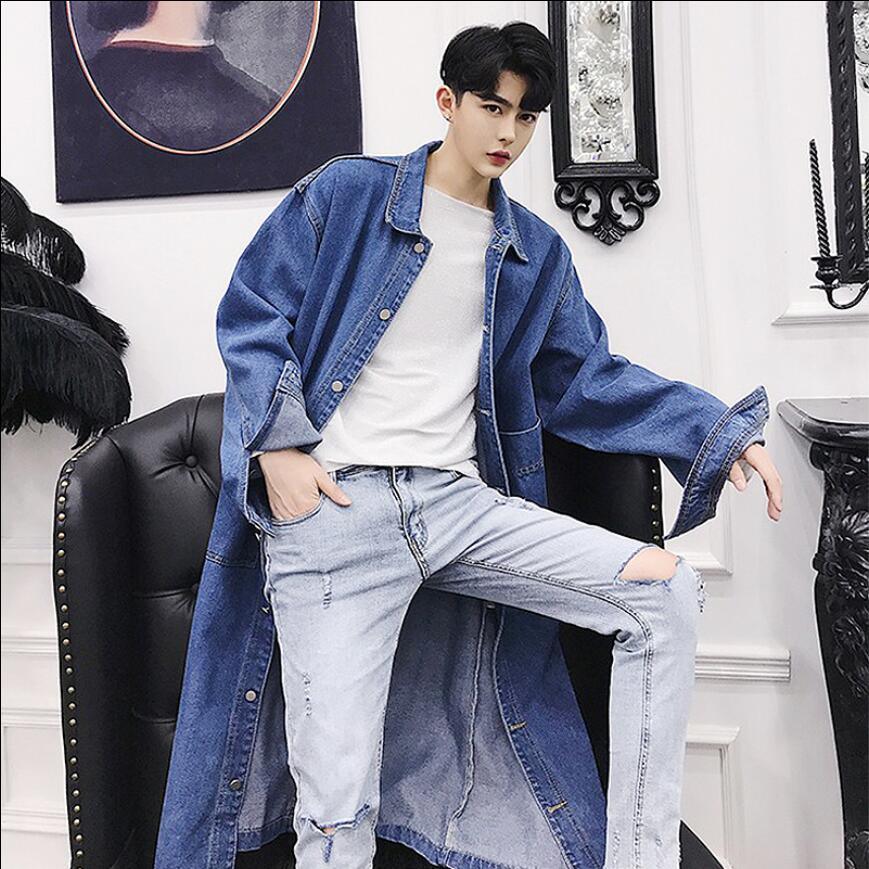 Blue denim trench coat with button front, long sleeves, and folded collar.
