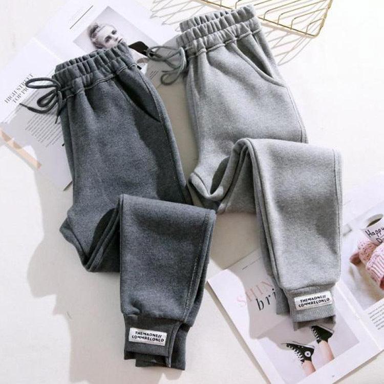 Set of grey harem jogger trousers with elastic waist and drawstring, cuffed hems
