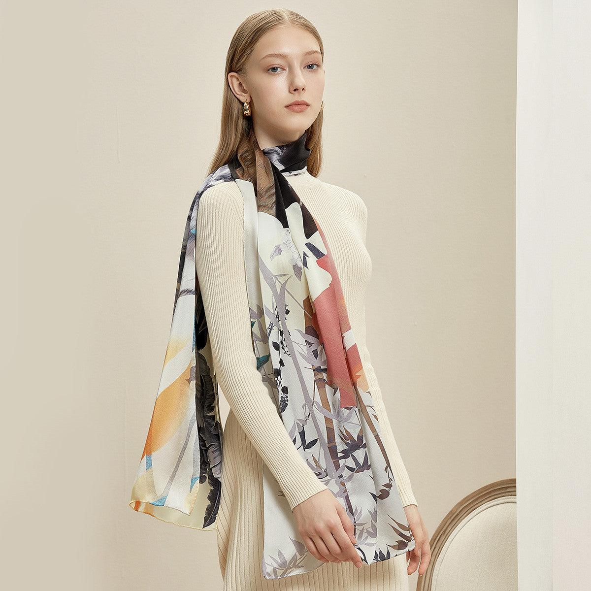 Silk scarf with pale base and multicolor abstract butterfly and leaf print, long ends