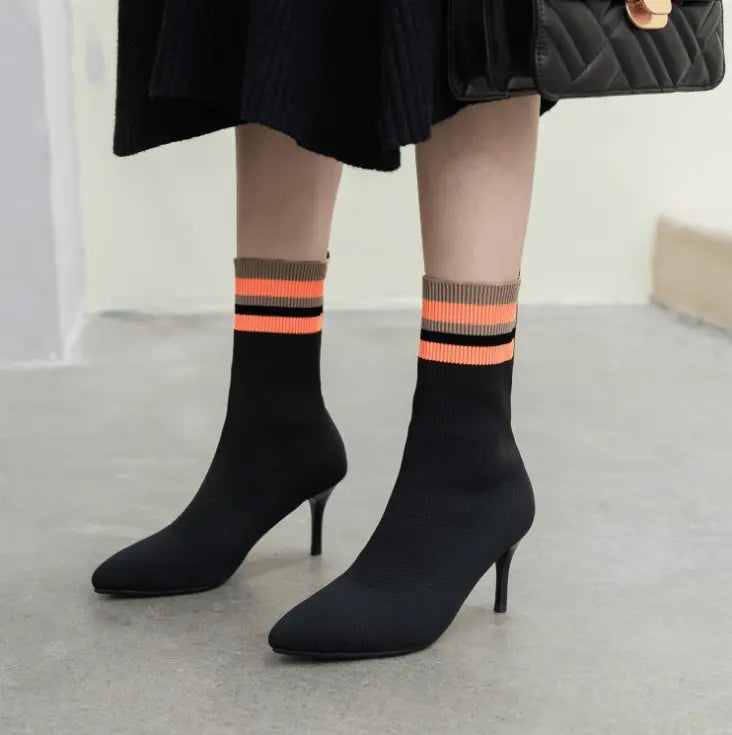 Black high-heel sock boots with orange striped cuffs and stiletto heels