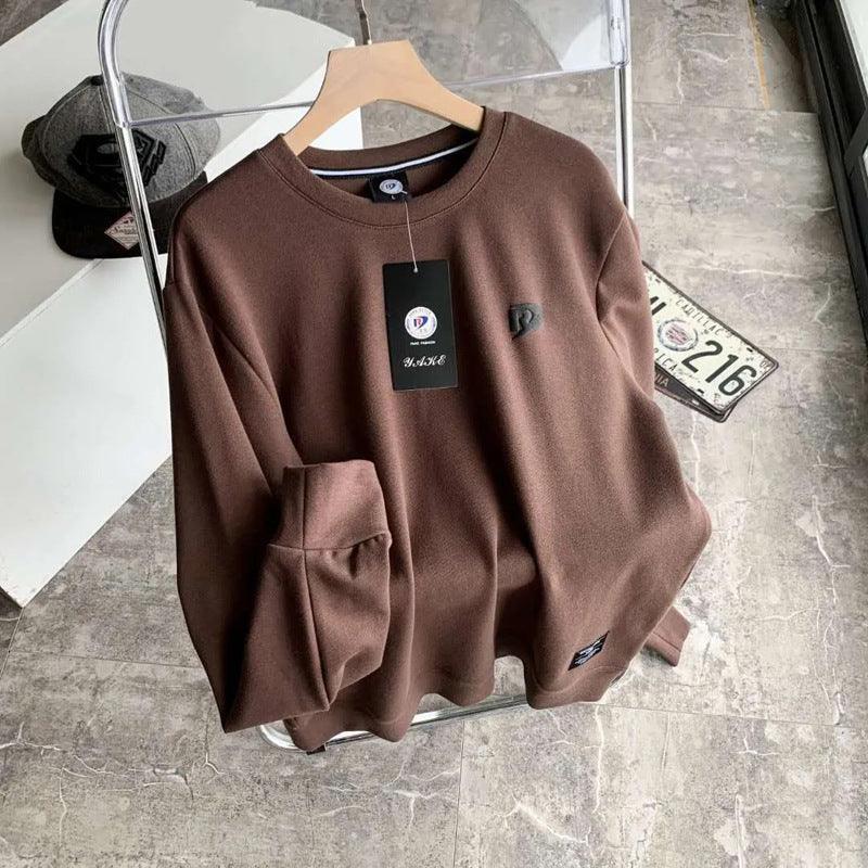 Brown long-sleeve pullover base shirt with crew neck, kangaroo pocket, and chest logo tag.