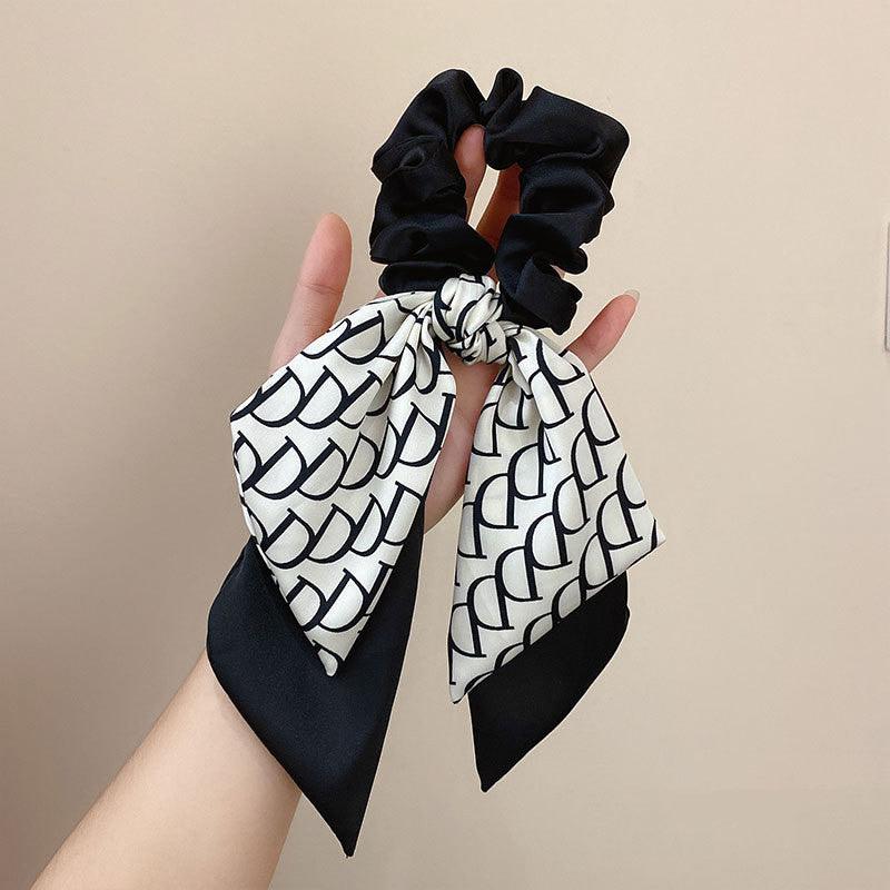 Satin hair headband with tied bow, black and white patterned scarf with scrunchie loop
