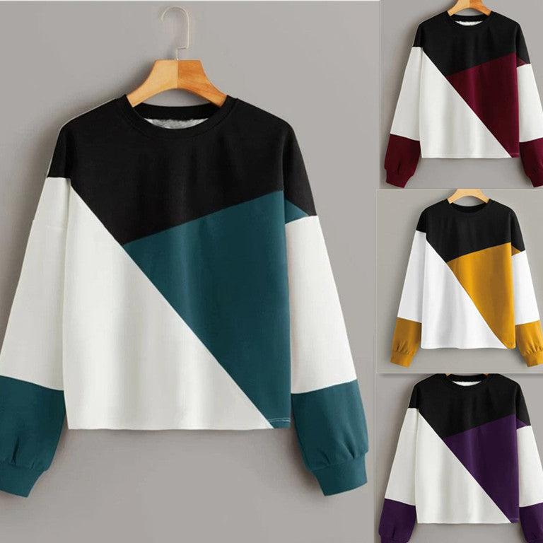 Patchwork round-neck pullover sweater with black, teal and white diagonal color blocks