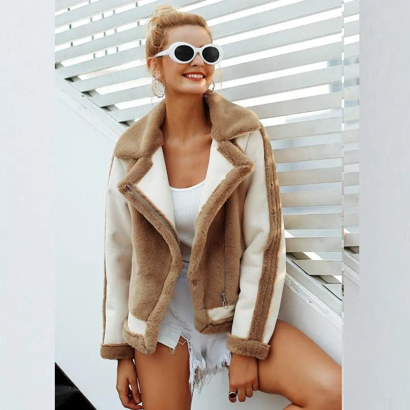 Tan faux fur coat with white sleeves, contrast trim, and stitched front closure