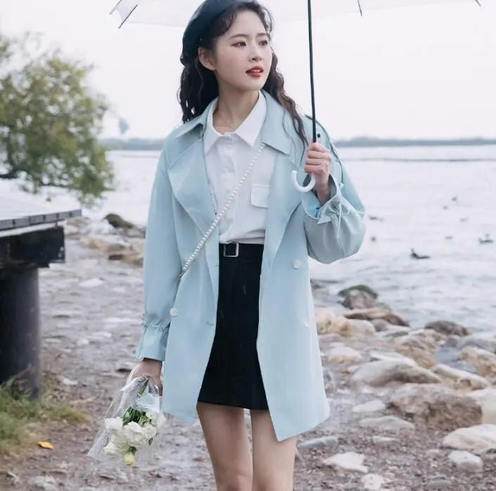 Light blue trench coat with collar, waist belt tie, and decorative heart chain