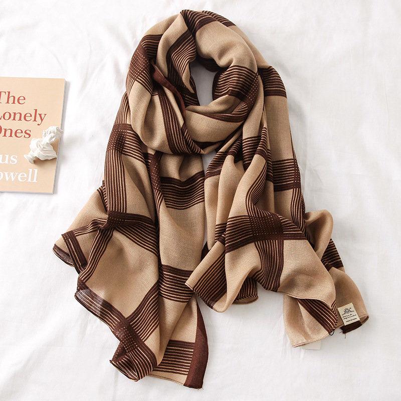 Silk scarf in beige with dark brown check and stripe pattern, folded and draped