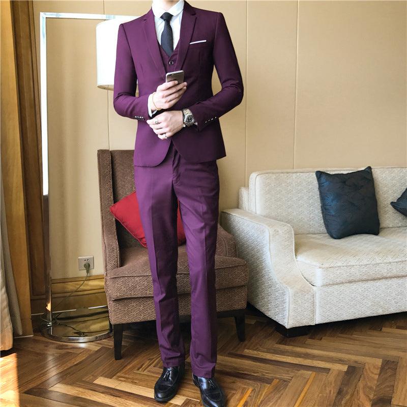 Men's burgundy suit with pocket square, white shirt, and striped tie