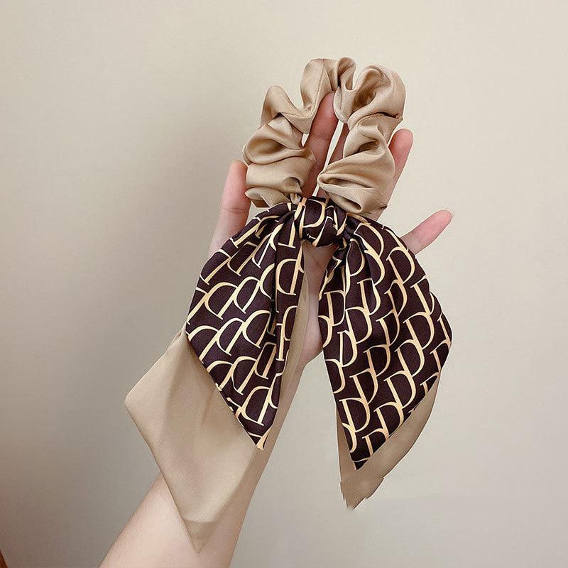Satin hair headband with tied bow, beige top and coffee-brown geometric pattern scarf