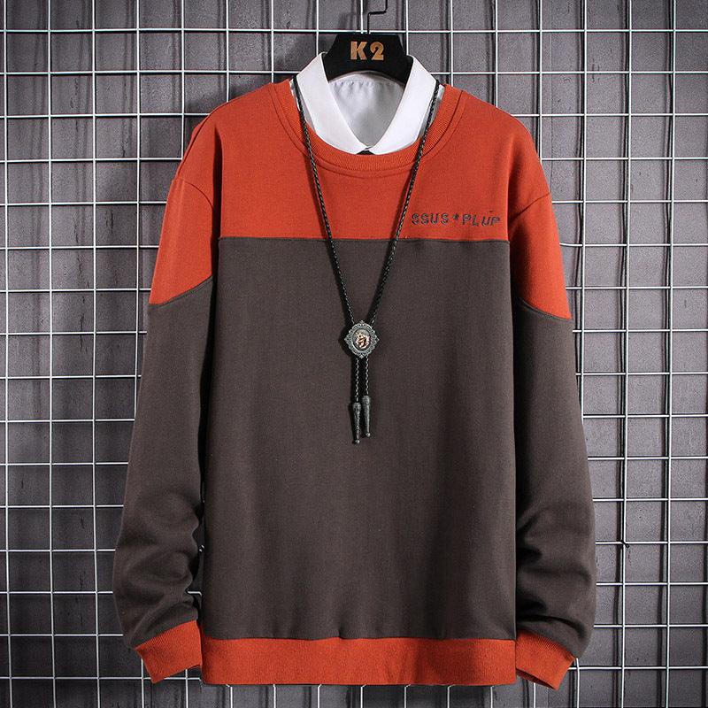 Colorblock long-sleeve round-neck top, dark charcoal body with rust-orange sleeves and hem