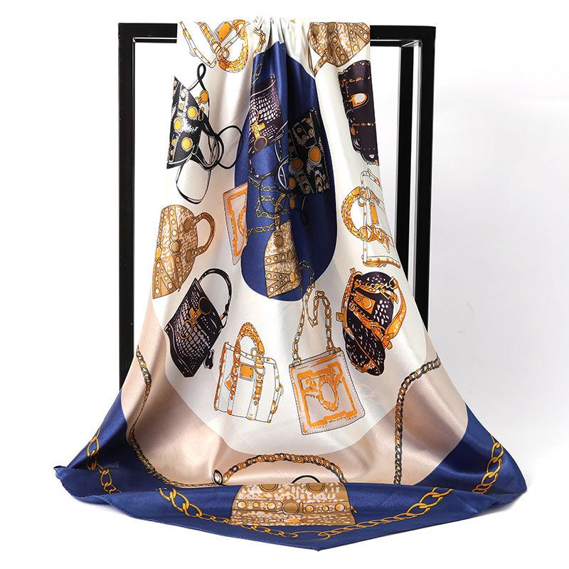 Women's silk scarf in cream with gold and navy chain and bag motifs