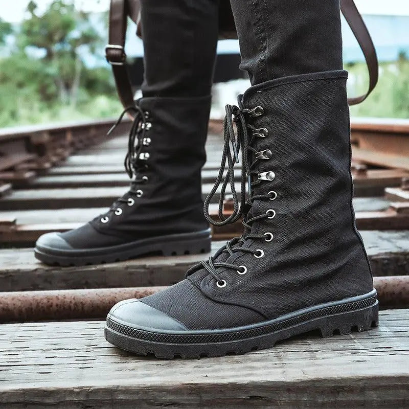 Black canvas lace-up high-top shoes with metal eyelets and thick rubber sole