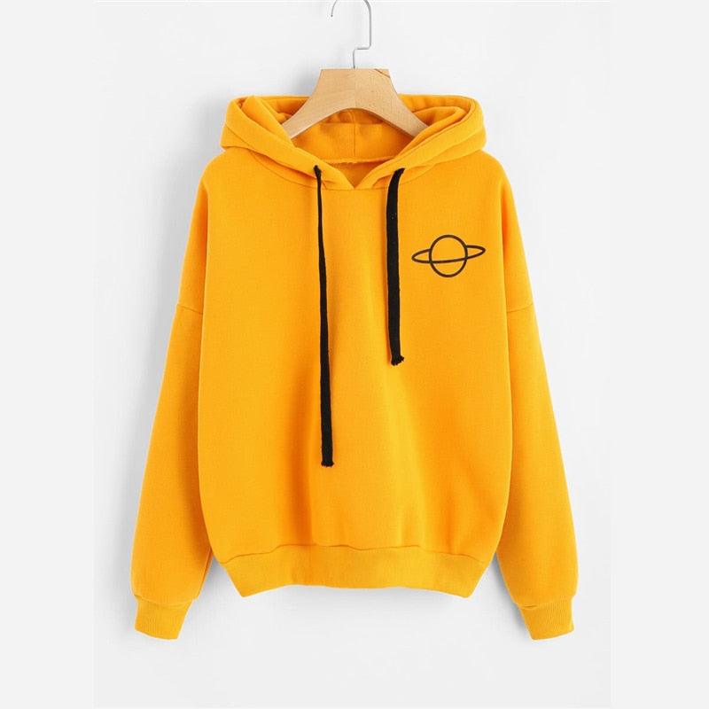 Mustard yellow pullover hoodie with hood, black drawstrings, front pocket, and planet emblem