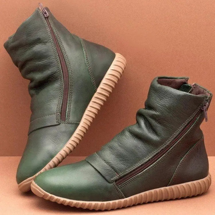 Green side-zip flat-bottom ankle boots on flat rubber sole with tan edge